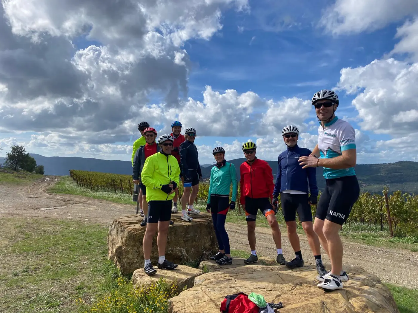 Tom Shooter with a group of cyclists among vineyards